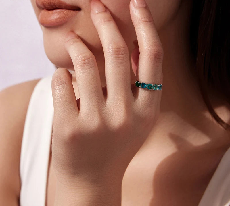 Close-up of a hand wearing a green ring 