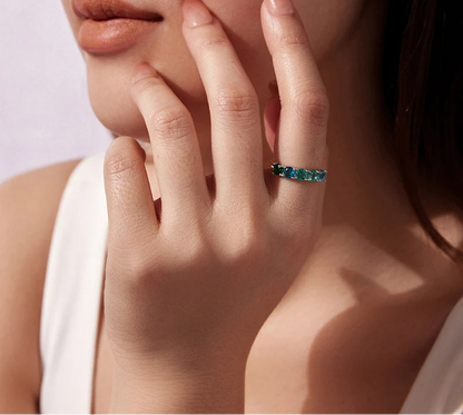 Close-up of a hand wearing a green ring 