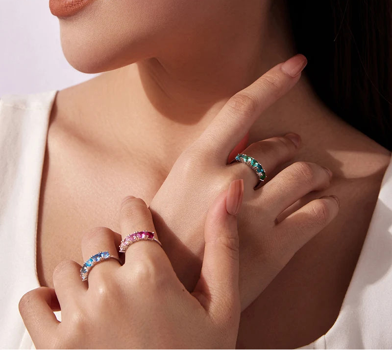 Close-up of a woman's hand wearing multiple rings with gemstones