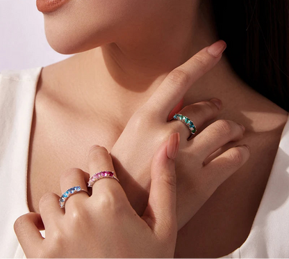 Close-up of a woman's hand wearing multiple rings with gemstones