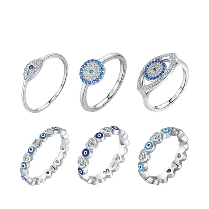 Set of silver rings with blue and white gemstones on a white background VAMORRA