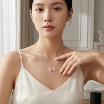 Woman wearing a delicate necklace with a butterfly pendant in a softly lit room.